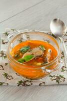 vegetable tomato soup with fish in a plate photo