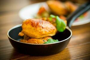 fried pieces of chicken fillet in a pan photo