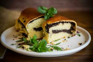 roll with poppy seeds inside on a wooden table. photo