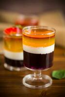 lot of colored sweet fruit jelly in a glass photo