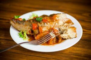 whole fish hake stewed with carrots, beets, peppers and other photo