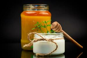 jar with natural homemade yogurt and delicious organic honey photo