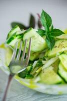 fresh organic cucumber salad with herbs and basil in a plate photo