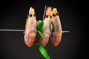 boiled shrimp with spices on black background photo