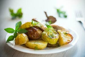 Early baked potatoes with zucchini and chicken photo