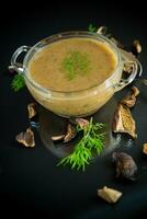 hot homemade vegetable vegetarian soup with dried mushrooms in a glass bowl photo