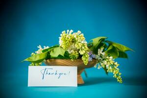 bouquet of white lilacs with greeting card photo
