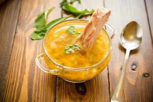 cooked pea soup with ribs smoked in a plate photo