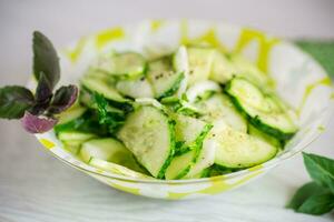 fresh organic cucumber salad with herbs and basil in a plate photo