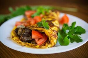 fried egg omelet with wild mushrooms and tomatoes photo