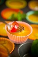 lot of colored sweet fruit jelly in a glass photo