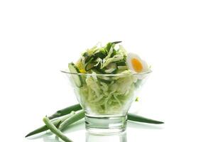 spring salad with early cabbage, cucumbers, eggs and green onions photo