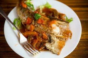 whole fish hake stewed with carrots, beets, peppers and other photo