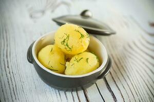 early boiled potato with butter and fresh dill photo