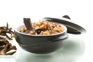 boiled buckwheat with organic forest dried mushrooms in a ceramic bowl photo