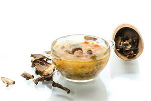 vegetarian vegetable soup with porcini mushrooms in a glass bowl photo