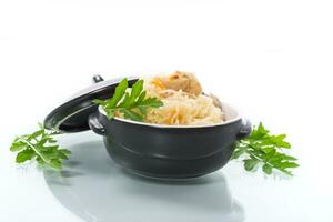 boiled rice with vegetables and meat in a ceramic bowl photo