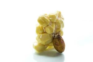 peeled potatoes closed in a vacuum bag and old sprouted potatoes photo