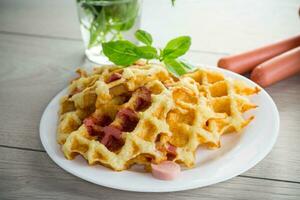 cooked fried potato waffles with sausage stuffing inside photo