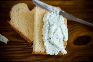 homemade salted curd spread with herbs and garlic photo