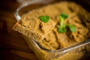 homemade meat pate with bread on a wooden table photo