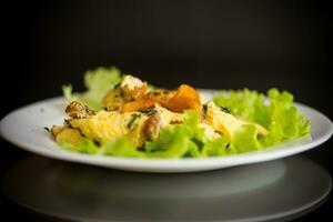 fried omelet with forest mushrooms chanterelles, on black background photo