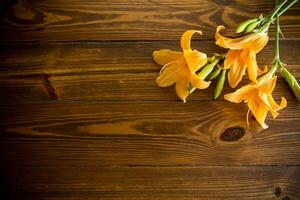 bouquet of beautiful yellow lilies on wooden table photo