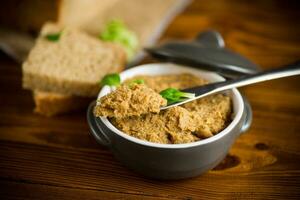 homemade meat pate in a ceramic bowl on a wooden table photo