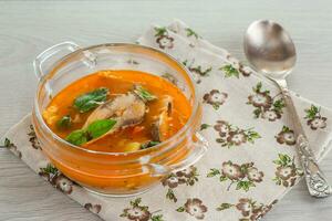 vegetable tomato soup with fish in a plate photo