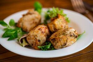 frito piezas de pollo filete empanizado con especias y hierbas en un plato . foto