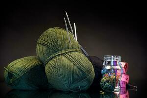 wool yarn, knitting needles and other tools for hand knitting. photo