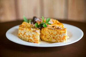 Cooked cottage cheese casserole with pieces of pumpkin inside. photo