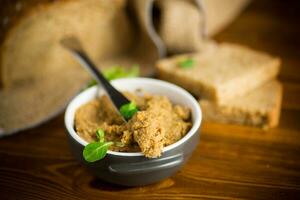 homemade meat pate in a ceramic bowl on a wooden table photo