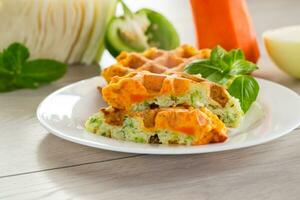 cooked two-color vegetable waffles made from cabbage and carrots. photo