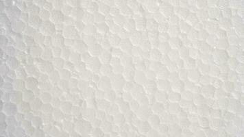 White foam sheet top view. Small and large clear foam beads, polystyrene sheet surface in closeup, close-up seamless background photo