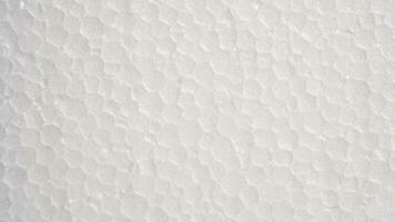 White foam sheet top view. Small and large clear foam beads, polystyrene sheet surface in closeup, close-up seamless background photo