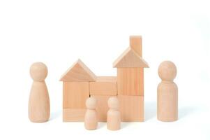 Wooden figurines of family father, mother, children. Wooden figurines concept. model house on a white background. Real estate purchase, rental concept. warm family concept. photo