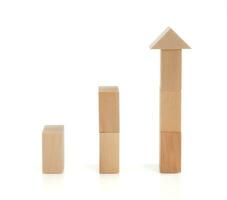 Business concept growth success process, statistics graph. Wooden blocks stacking as an arrow up averages as a growth graph chart on white background. photo