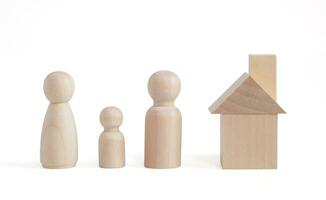 Wooden figurines family father, mather, children. Wooden figurines concept. model house on a white background. Real estate purchase, rental concept. warm family concept. photo