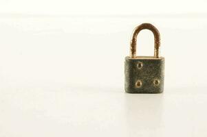 a small lock on a white surface photo