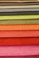 a large pile of different colored fabrics photo