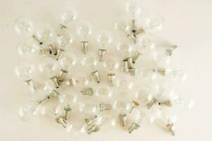 a large group of light bulbs on a white surface photo