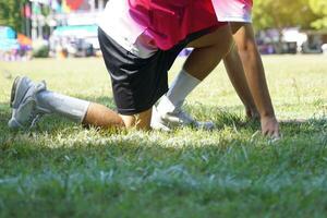 Runners wearing pink shirts are ready to start at the starting point. Soft and selective focus. photo