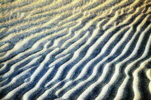 the sand is covered with ripples and patterns photo