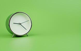 White modern alarm clock on a light green background. Time concept and working with precious time photo