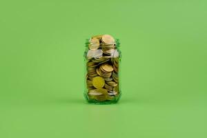 Saving coins in a glass jar Finance, banking, investments, financial growth Financial income, cash flow, income and expenses photo