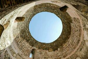 the inside of a stone building with a circular window photo