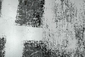 Abstract grunge texture pattern of black paint on white wall photo