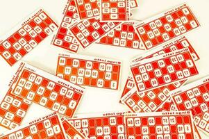 a pile of red and white stickers with numbers photo