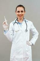 Female doctor  holding injection. photo